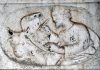 San Luca evangelista, bassorilievi sui due pilastri della Scuola dei Pittori, nel Sestiere di Cannaregio